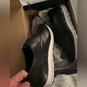 Cole Haan women’s black leather Oxford shoe.